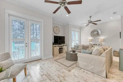 a living room with a couch and a ceiling fan at Lucky Beach in Inlet Beach