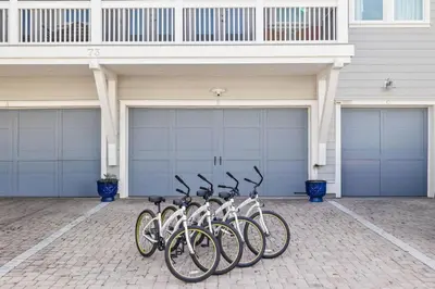 a row of bikes parked in front of garage doors at Amen 30A in Inlet Beach