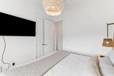 a bedroom with a bed and a flat screen tv at Journey to 30A in Inlet Beach