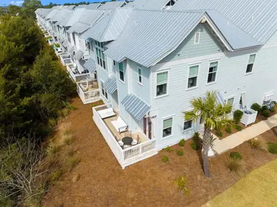 an aerial view of a large blue house at Journey to 30A in Inlet Beach