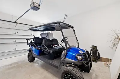a golf cart is parked in a garage at Journey to 30A in Inlet Beach