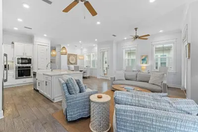 a living room with two couches and a kitchen at Kelly's Cabana in Inlet Beach