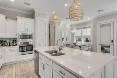 a kitchen with white cabinets and a white counter top at 30Yay Home in Inlet Beach