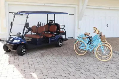 a golf cart with a bike parked next to it at 30Yay Home in Inlet Beach