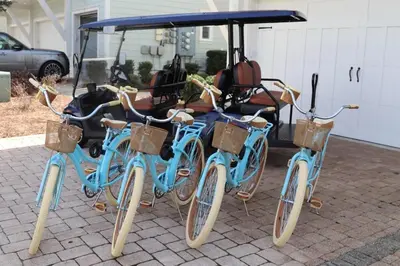 three bikes parked next to a golf cart at 30Yay Home in Inlet Beach