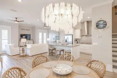 a kitchen and dining room with a table and chairs at Lala's Beach House in Inlet Beach