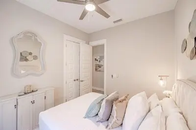 a bedroom with a bed with a ceiling fan at Lala's Beach House in Inlet Beach