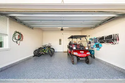a garage with a golf cart parked in it at Beachwood Hideaway in Inlet Beach