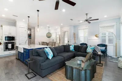 a large living room with a couch and a kitchen at Seas the Day in Inlet Beach