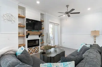 a living room with a couch and a fireplace at Seas the Day in Inlet Beach