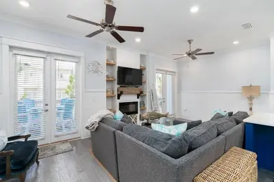 a living room with a couch and a ceiling fan at Seas the Day in Inlet Beach