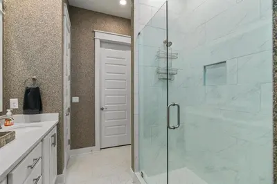 a bathroom with a shower with a glass door at Seas the Day in Inlet Beach