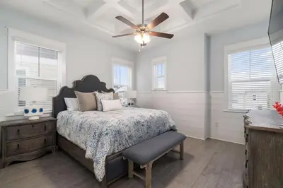 a bedroom with a bed and a ceiling fan at Seas the Day in Inlet Beach