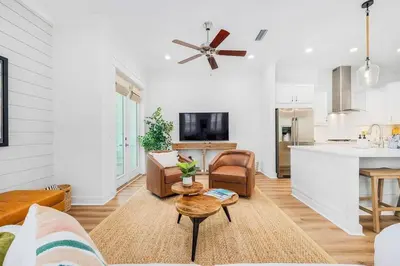 a living room with a couch and a table at Sea'n is Believe'n in Inlet Beach
