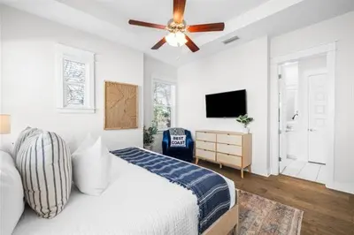 a bedroom with a bed and a ceiling fan at Sea'n is Believe'n in Inlet Beach