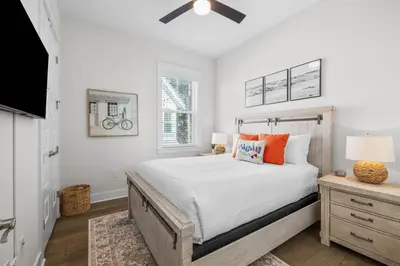 a bedroom with a large bed and a window at Sea'n is Believe'n in Inlet Beach