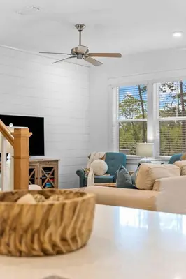 a living room with a couch and a tv at Just Beachy in Inlet Beach