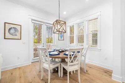 a dining room with a table and chairs at Just Beachy in Inlet Beach