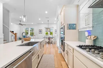 a kitchen with a sink and a stove top oven at Just Beachy in Inlet Beach