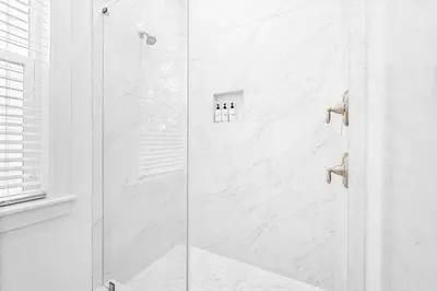 a shower with a glass door in a bathroom at Just Beachy in Inlet Beach