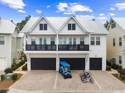 a house with a motorcycle parked in front of it at Just Beachy in Inlet Beach
