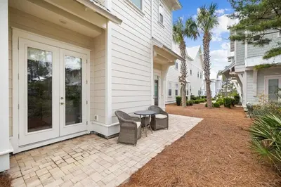 a patio with a table and chairs on a house at Skippy's Hideaway in Inlet Beach