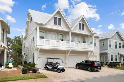 a golf cart parked in front of a house at Skippy's Hideaway in Inlet Beach