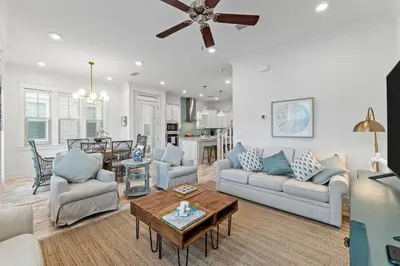 a living room with two couches and a table at License to Chill in Inlet Beach