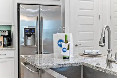 a bottle of wine sitting on top of a kitchen counter at License to Chill in Inlet Beach