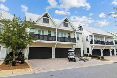a house with a golf cart in front of it at License to Chill in Inlet Beach