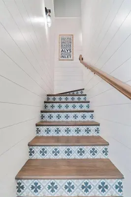 a staircase with blue and white tiles on the stairs at Isle be 'SEA'ing You in Inlet Beach