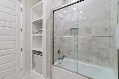 a bathroom with a shower with a glass door at Isle be 'SEA'ing You in Inlet Beach