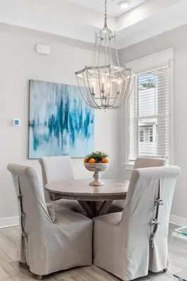 a dining room table with chairs and a chandelier at Isle be 'SEA'ing You in Inlet Beach