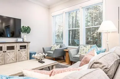 a living room with a couch and chairs and a tv at BeachHaven 30A in Inlet Beach