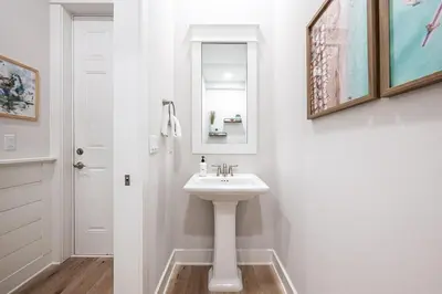 a white bathroom with a sink and a mirror at BeachHaven 30A in Inlet Beach
