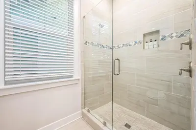 a shower with a glass door in a bathroom at BeachHaven 30A in Inlet Beach
