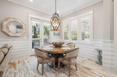 a dining room with a table and chairs and a mirror at Sand Dollar Dream in Inlet Beach