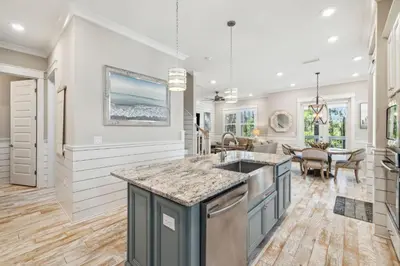 a kitchen with a island and a dining room at Sand Dollar Dream in Inlet Beach