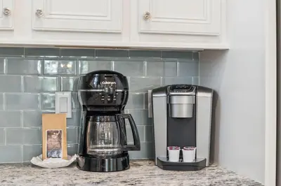 a black coffee maker sitting on a kitchen counter at Sand Dollar Dream in Inlet Beach