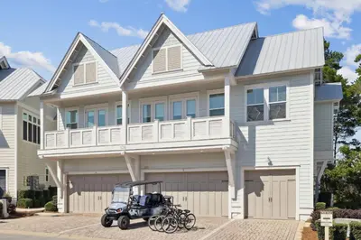 a house with a golf cart parked in front of it at Sand Dollar Dream in Inlet Beach