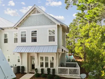 a white house with a blue roof at Sand Dollar Dream in Inlet Beach