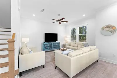 a living room with two white couches and a tv at SaltLife30A in Inlet Beach