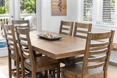 a wooden table with chairs and a bowl of rocks on it at SaltLife30A in Inlet Beach