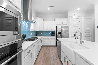 a white kitchen with a sink and a refrigerator at SaltLife30A in Inlet Beach