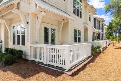 a house with a white fence on a porch at SaltLife30A in Inlet Beach