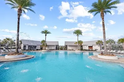 a large swimming pool with palm trees in a resort at SaltLife30A in Inlet Beach