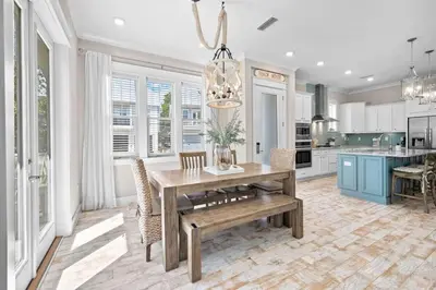 a kitchen with a wooden table and a dining room at Surfers Retreat in Inlet Beach