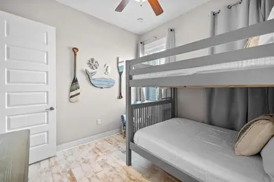 a bedroom with two bunk beds and a door at Surfers Retreat in Inlet Beach