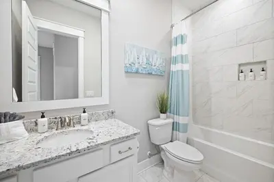 a white bathroom with a sink and a toilet at Surfers Retreat in Inlet Beach