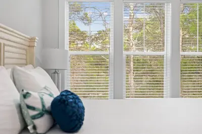 a bedroom with a bed with a blue ball on it at Serenity Sunset in Inlet Beach